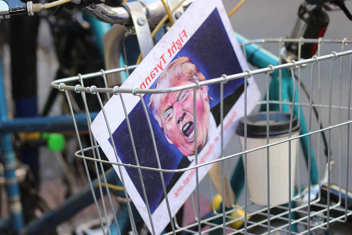 los angeles Donald Trump paper inside bicycle basket politics